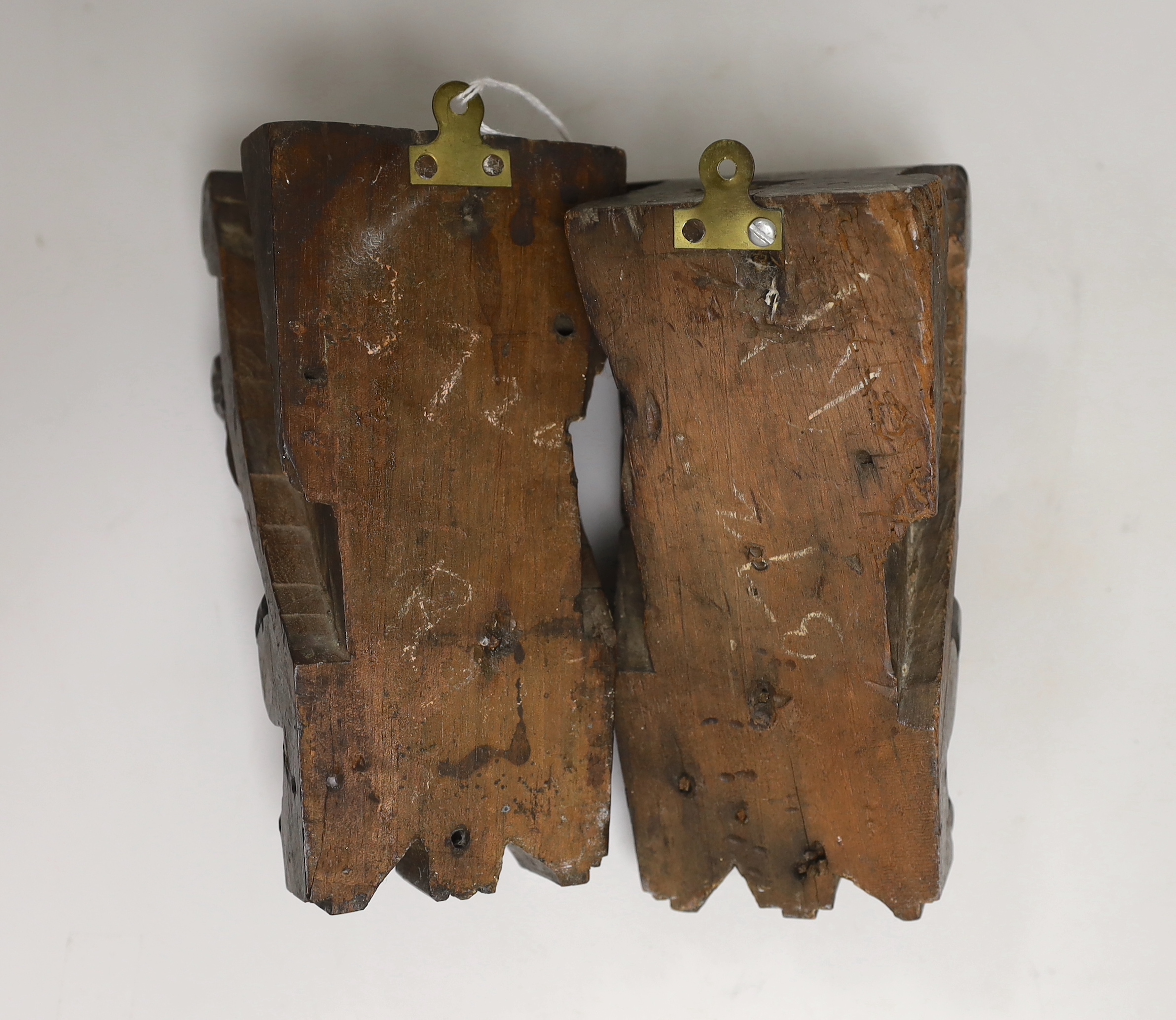 A pair of Italian carved walnut putti corbels, 18cm high